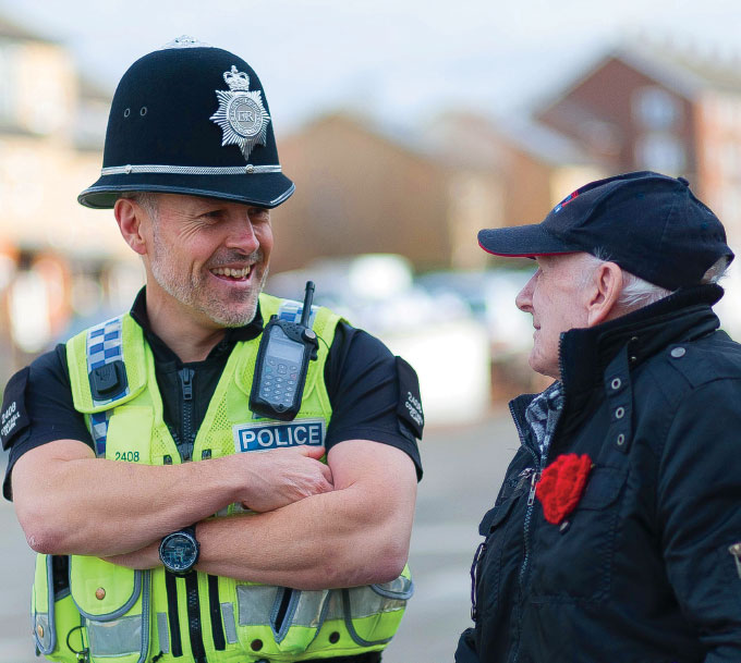 Police officer talking to elderly gentleman