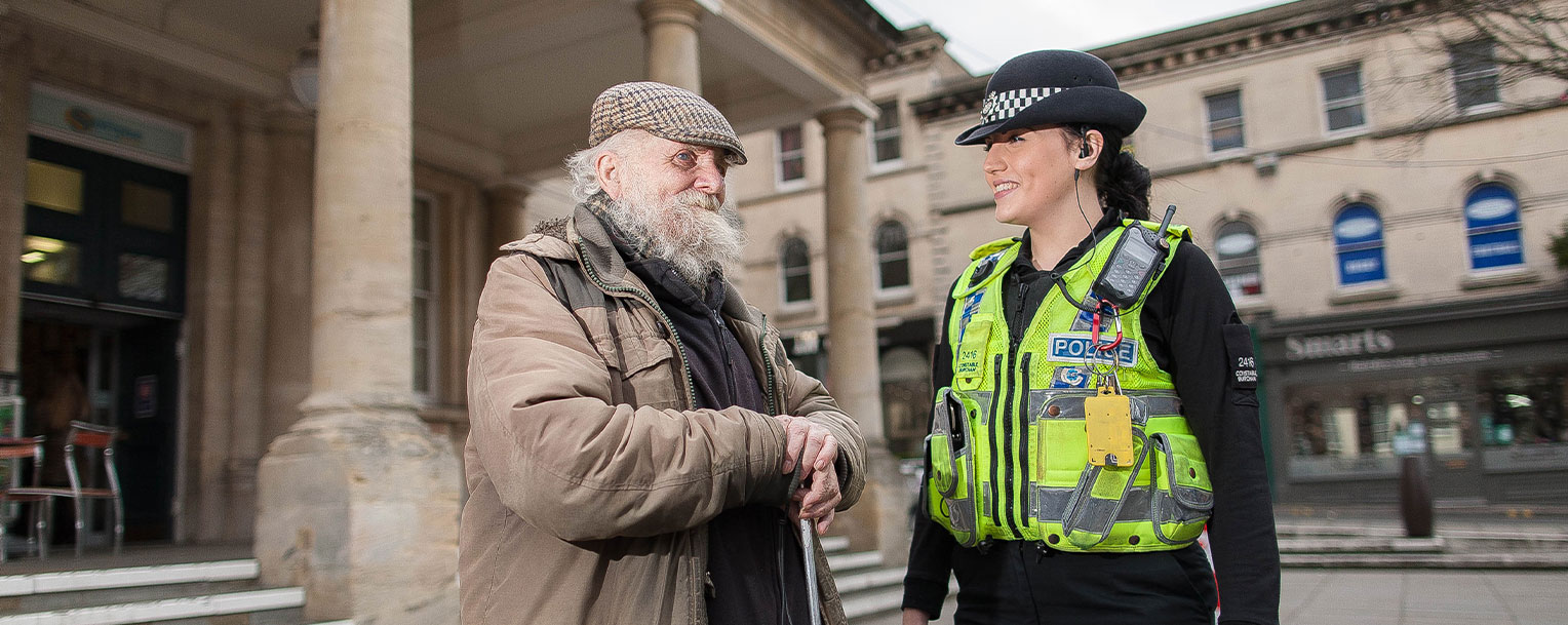 Policewoman talking to elderly gentleman